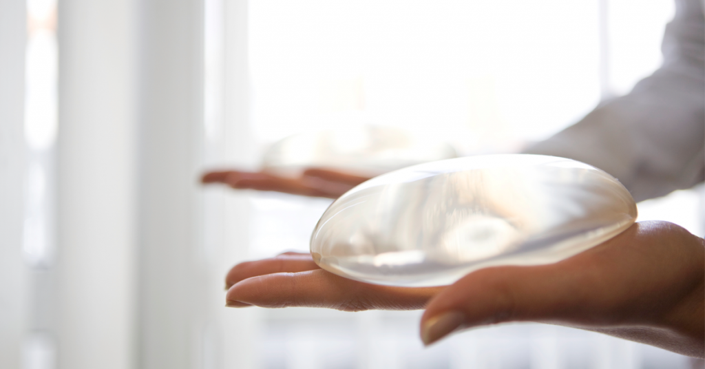 Person holding silicone breast implants
