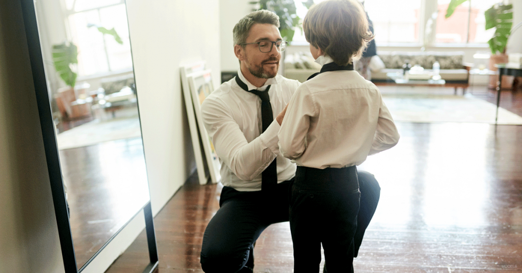 Dad with son getting dressed